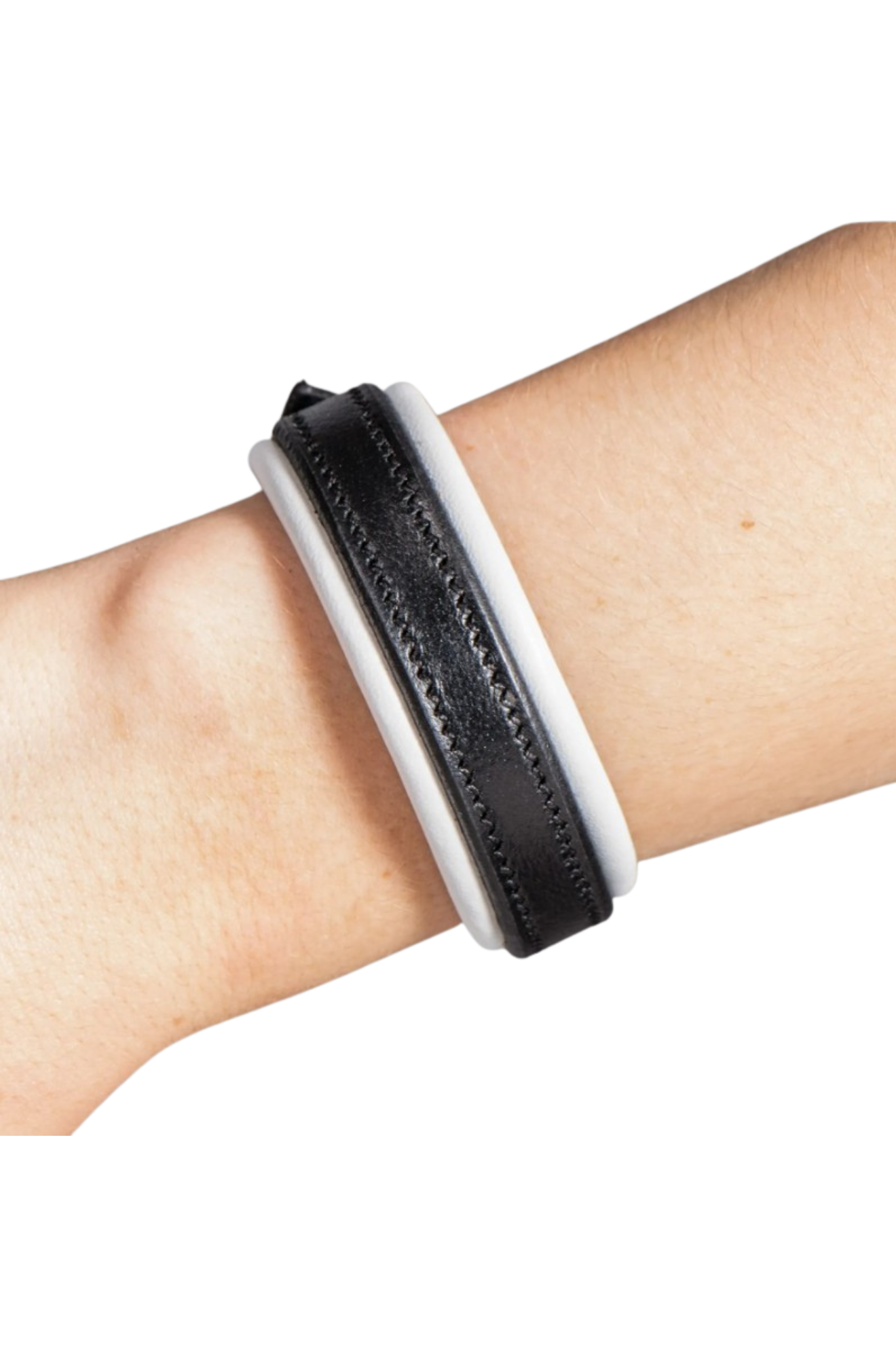 Black and white textured wristband on a wrist against a white background