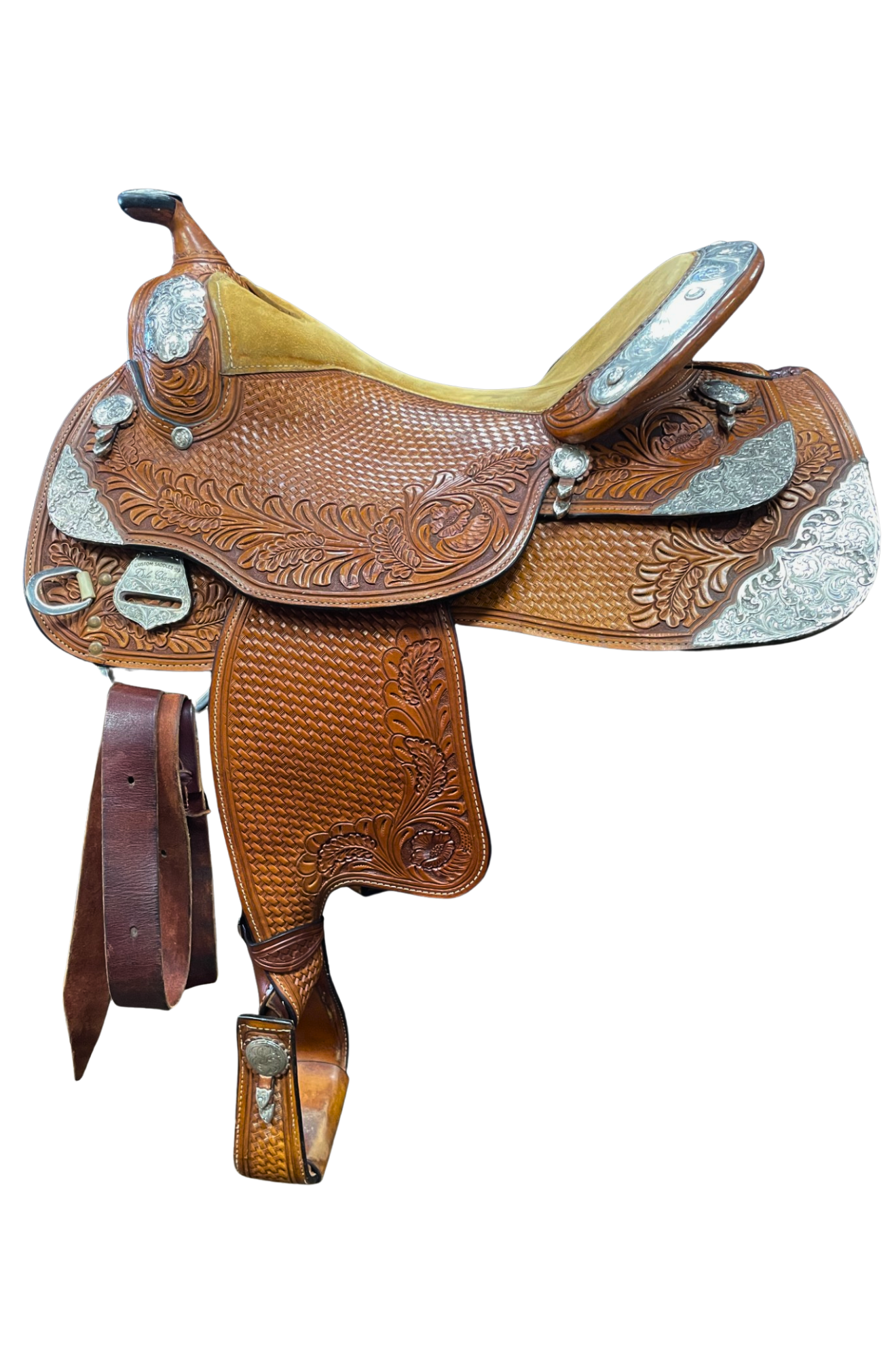 Brown leather saddle with intricate designs on a white background