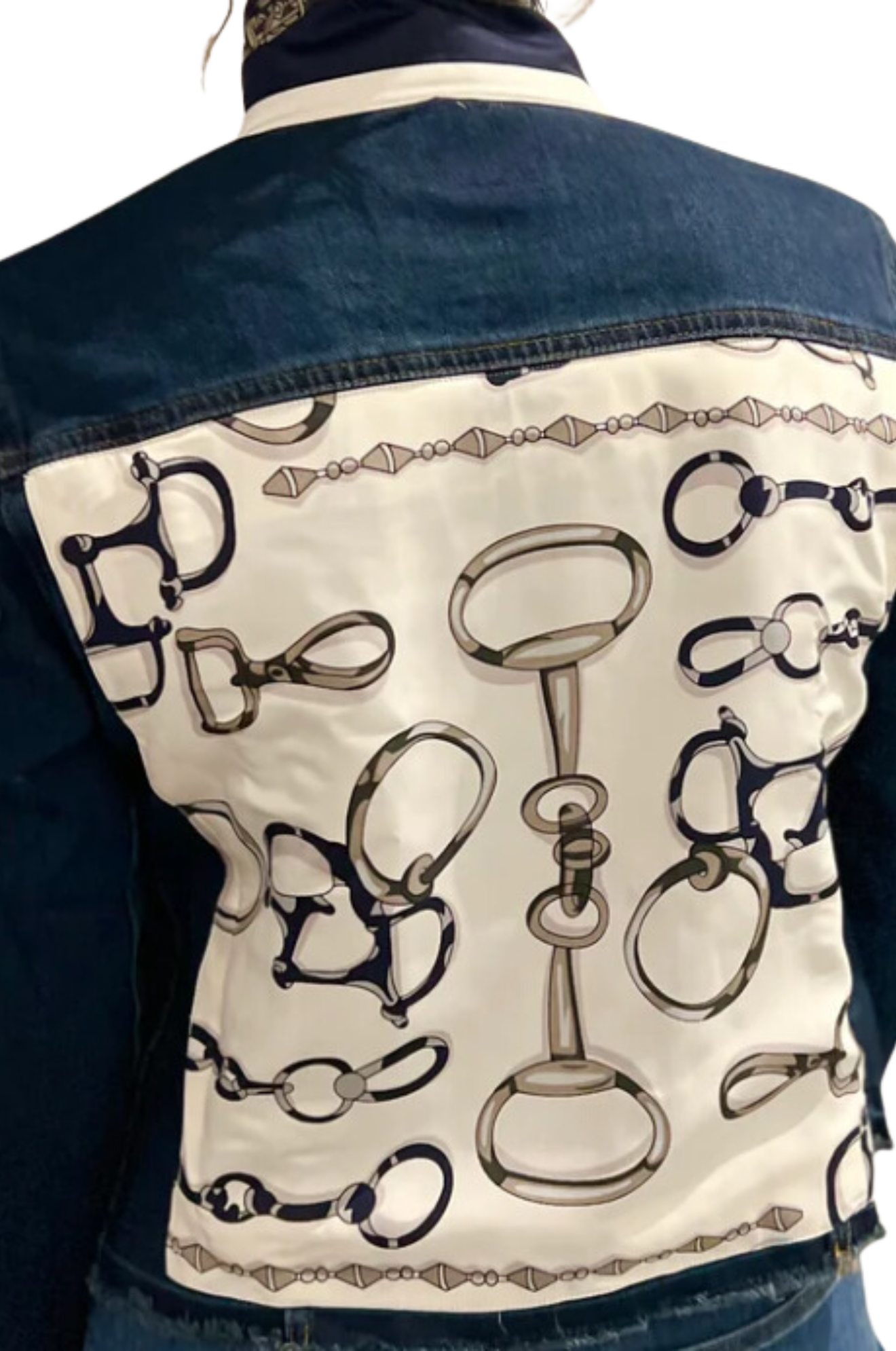 The image displays the back view of a blue denim jacket with a decorative pattern featuring gold and white elements.