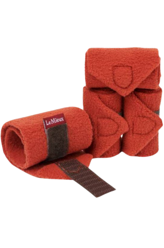 A set of red horse bandages with brown straps.