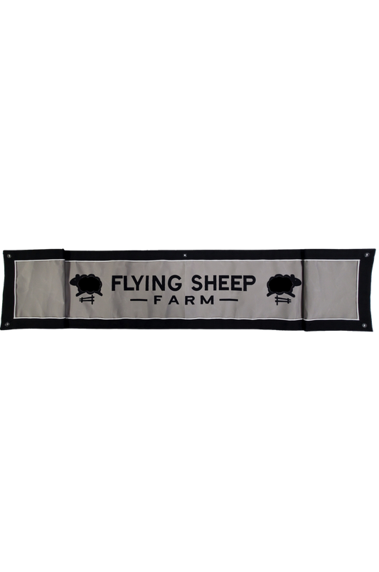 A custom valance banner with the text 'FLYING SHEEP FARM' along with an image of sheep on it, against a black background.
