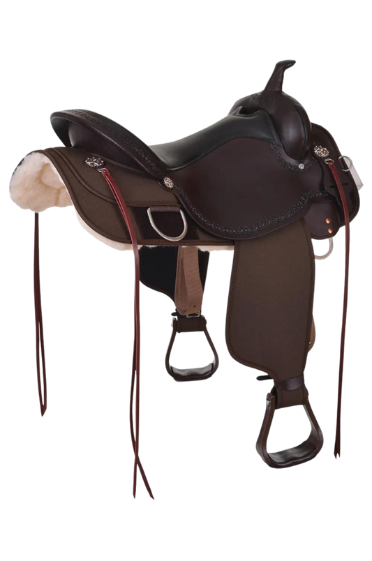 A brown Circle Y Magnolia Cordura Trail saddle with stainless hardware and copper flower conchos.