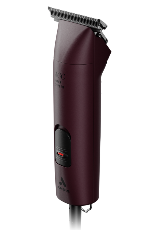 A set of ANDIS clippers in red color with a blade attached and a power cord, designed for animal grooming.