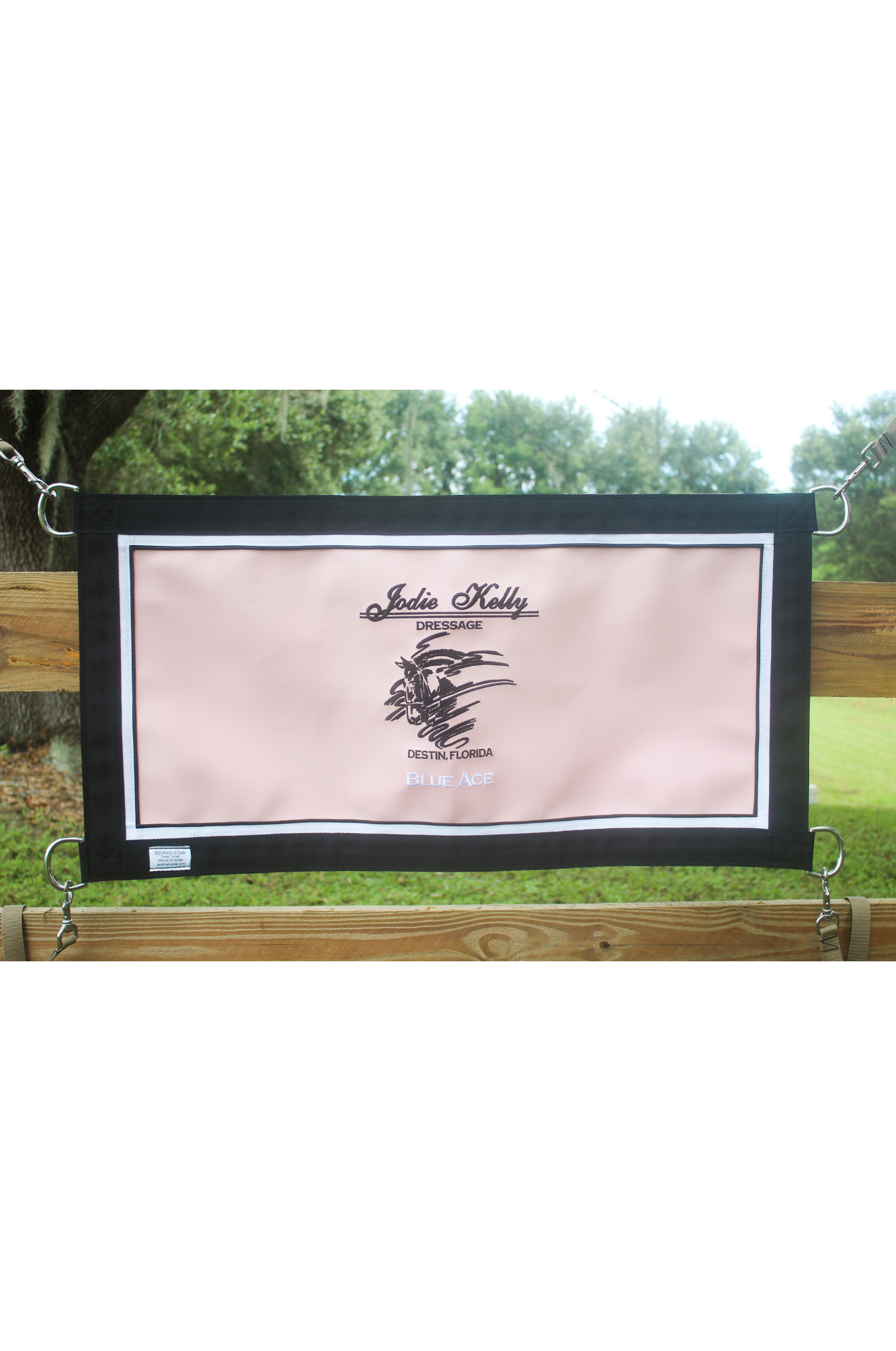 A custom stall guard with a solid blue background, white boarder and piping, displaying the text 'Henley C. Fletcher'.