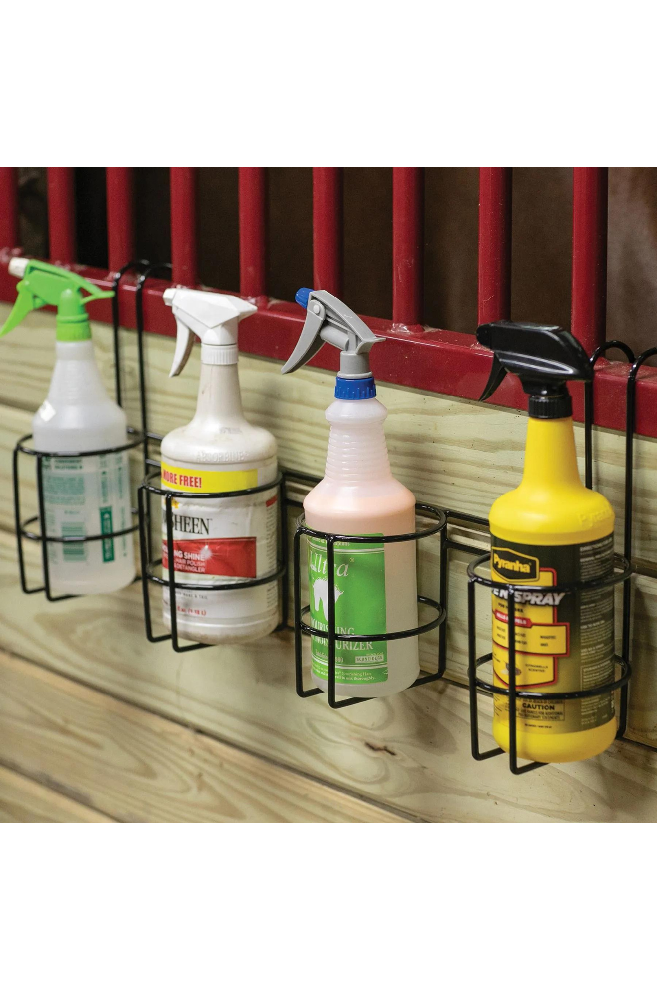 A wire spray bottle holder designed to hang over stalls, fences, or gates.