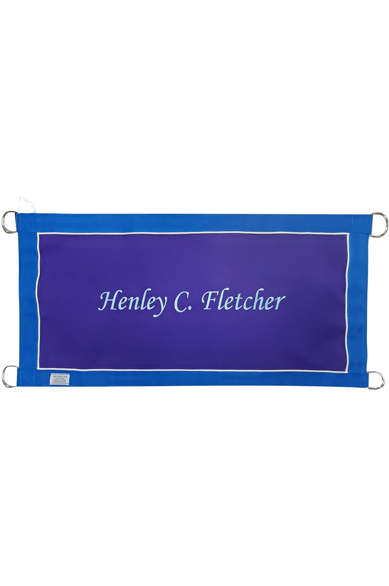 A custom stall guard with a solid blue background, white boarder and piping, displaying the text 'Henley C. Fletcher'.