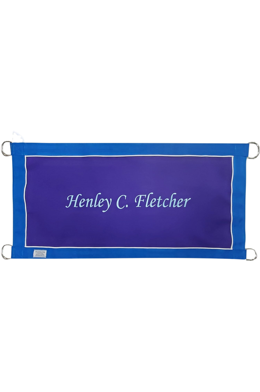 A custom stall guard with a solid blue background, white boarder and piping, displaying the text 'Henley C. Fletcher'.