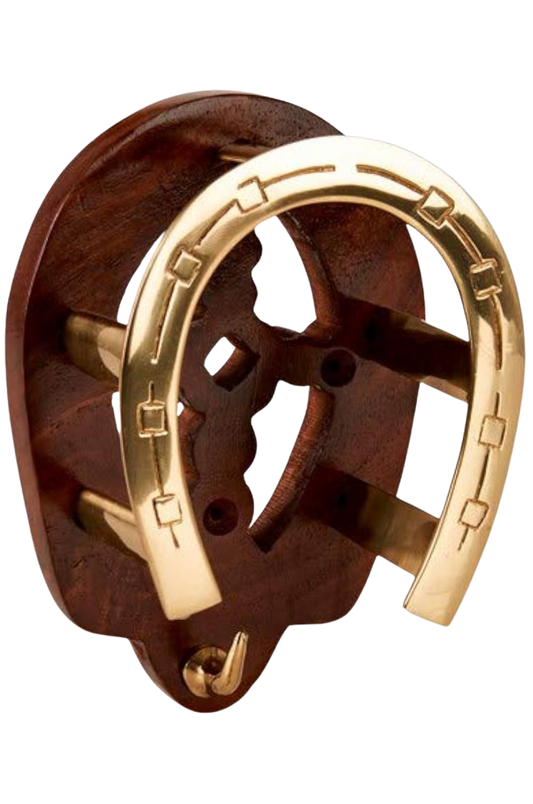 A golden horse shoe with a bridle bracket attached to it, displayed against a white background.