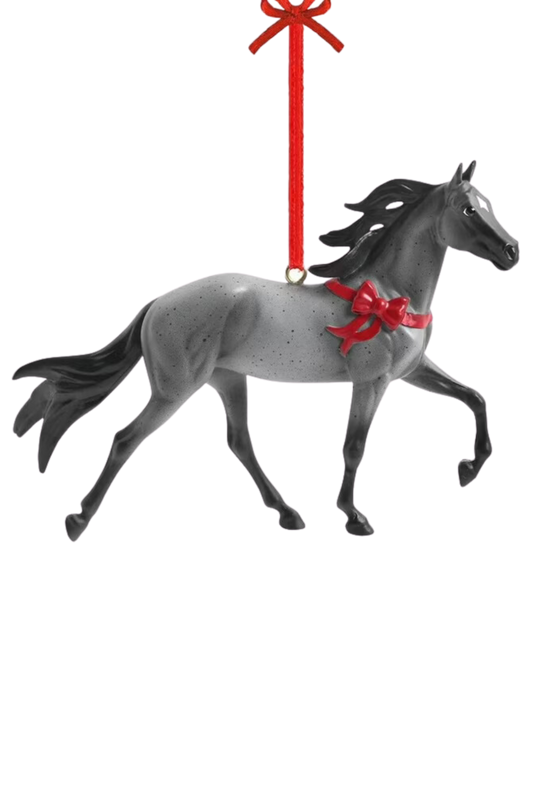 A festive holiday ornament of a gray Tennessee Walking Horse with a red bow around its neck, designed by artist Sommer Prosser.