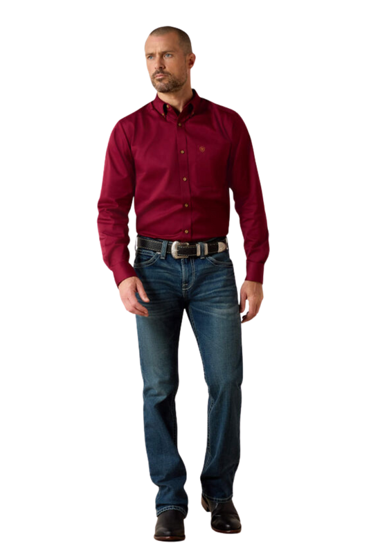 Man wearing a red shirt and blue jeans on a white background