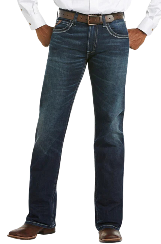 Blue jeans worn with a white shirt and brown shoes on a white background