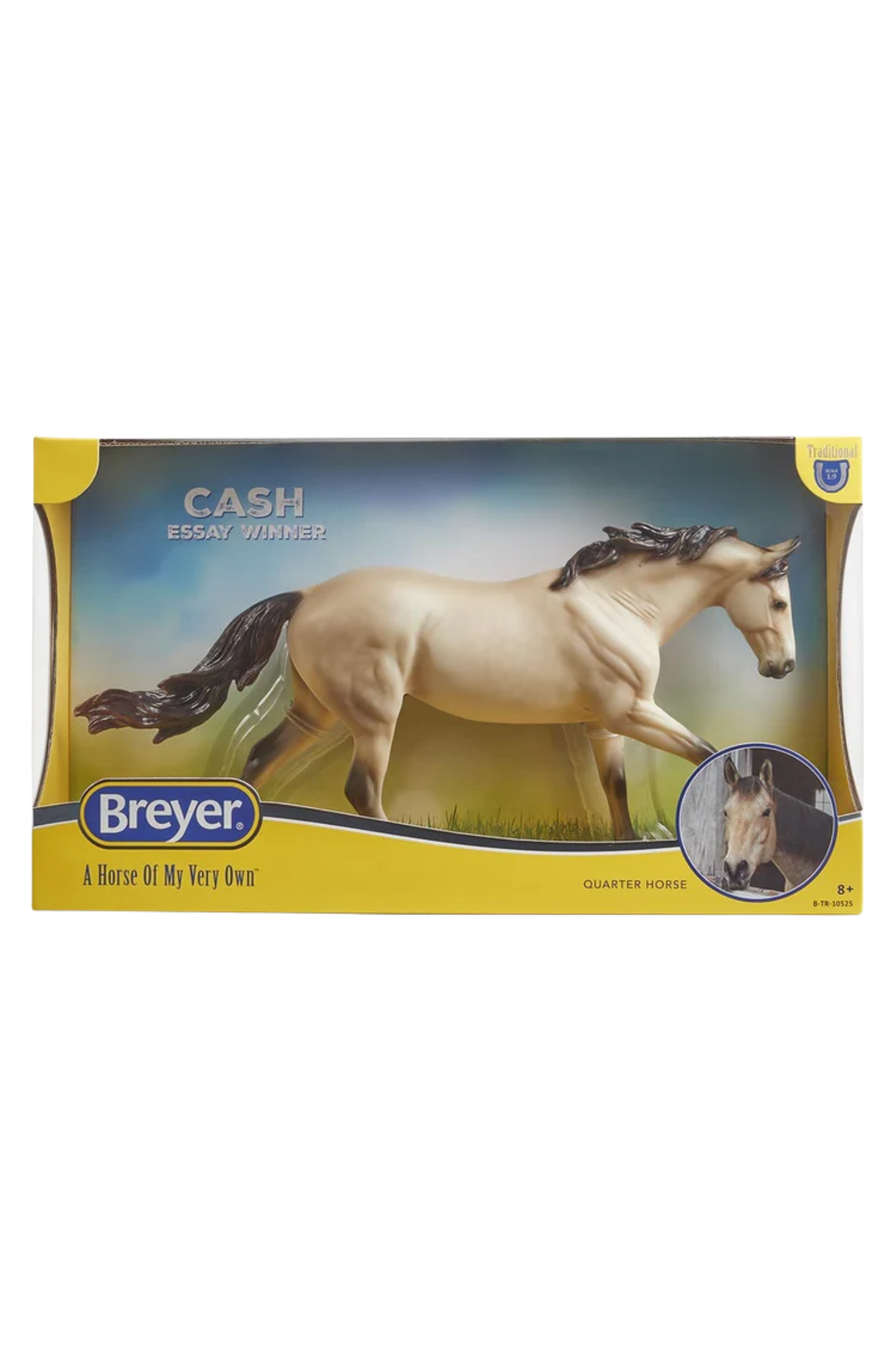 Breyer model horse in packaging with a white horse on a grassy field