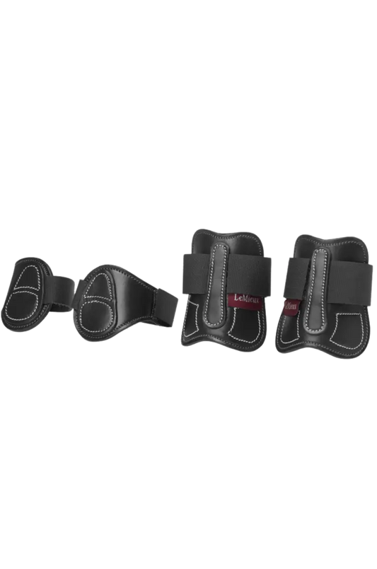 Set of four black protective pads on a white background