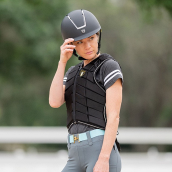 woman with riding helmet and safety vest on