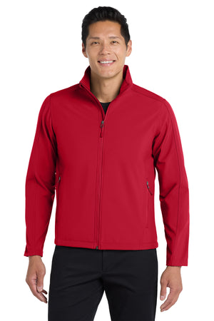 A man wearing a gray softshell jacket with a zip-through cadet collar, chin guard, and front zippered pockets.