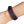 Purple and black leather wrap on a wrist against a white background