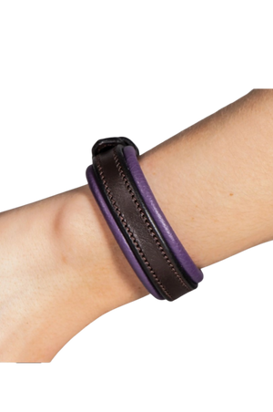 Purple and black leather wrap on a wrist against a white background