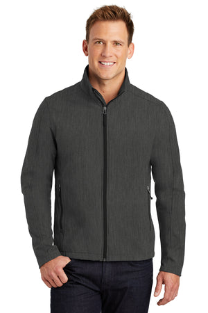 A man wearing a gray softshell jacket with a zip-through cadet collar, chin guard, and front zippered pockets.