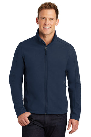 A man wearing a gray softshell jacket with a zip-through cadet collar, chin guard, and front zippered pockets.