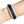 Black and white textured wristband on a wrist against a white background