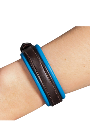 Blue and brown leather bracelet on a wrist against a white background