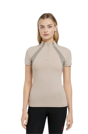 Woman wearing a beige short-sleeve top with a zipper on a white background