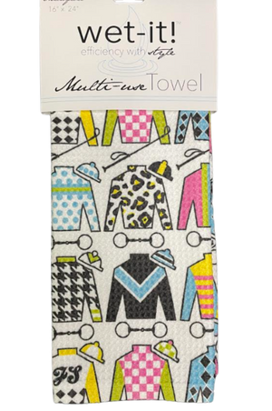 A multicolored kitchen towel with a racing silks design, featuring patterns resembling horse racing outfits, packaged with a 'wet-it! multi-use towel' label.