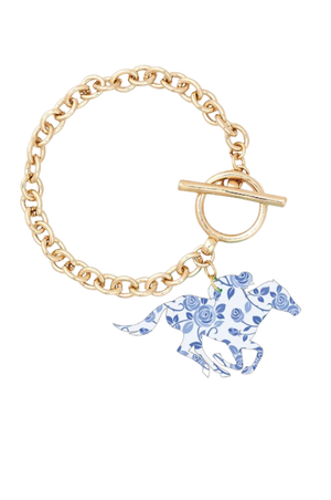 A gold chain link bracelet with a toggle clasp and a charm featuring a bright diamond pattern.