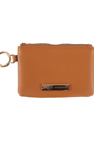 A brown faux leather coin purse with a zipper closure and a metal key ring attached.