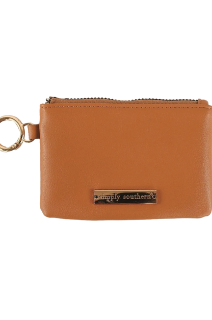 A brown faux leather coin purse with a zipper closure and a metal key ring attached.