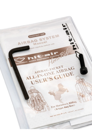 Hit-Air airbag system instruction booklet and tool kit, including a CO2 cartridge replacement tool, packaged in a clear plastic cover.