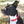 A dog wearing a biothane collar with brass hardware including a buckle and a D-ring.