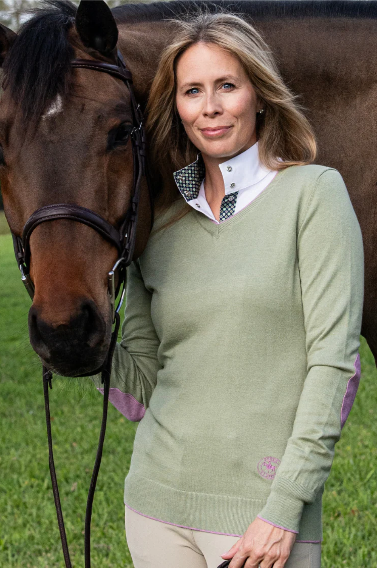 Green sweater with purple accents on a white background