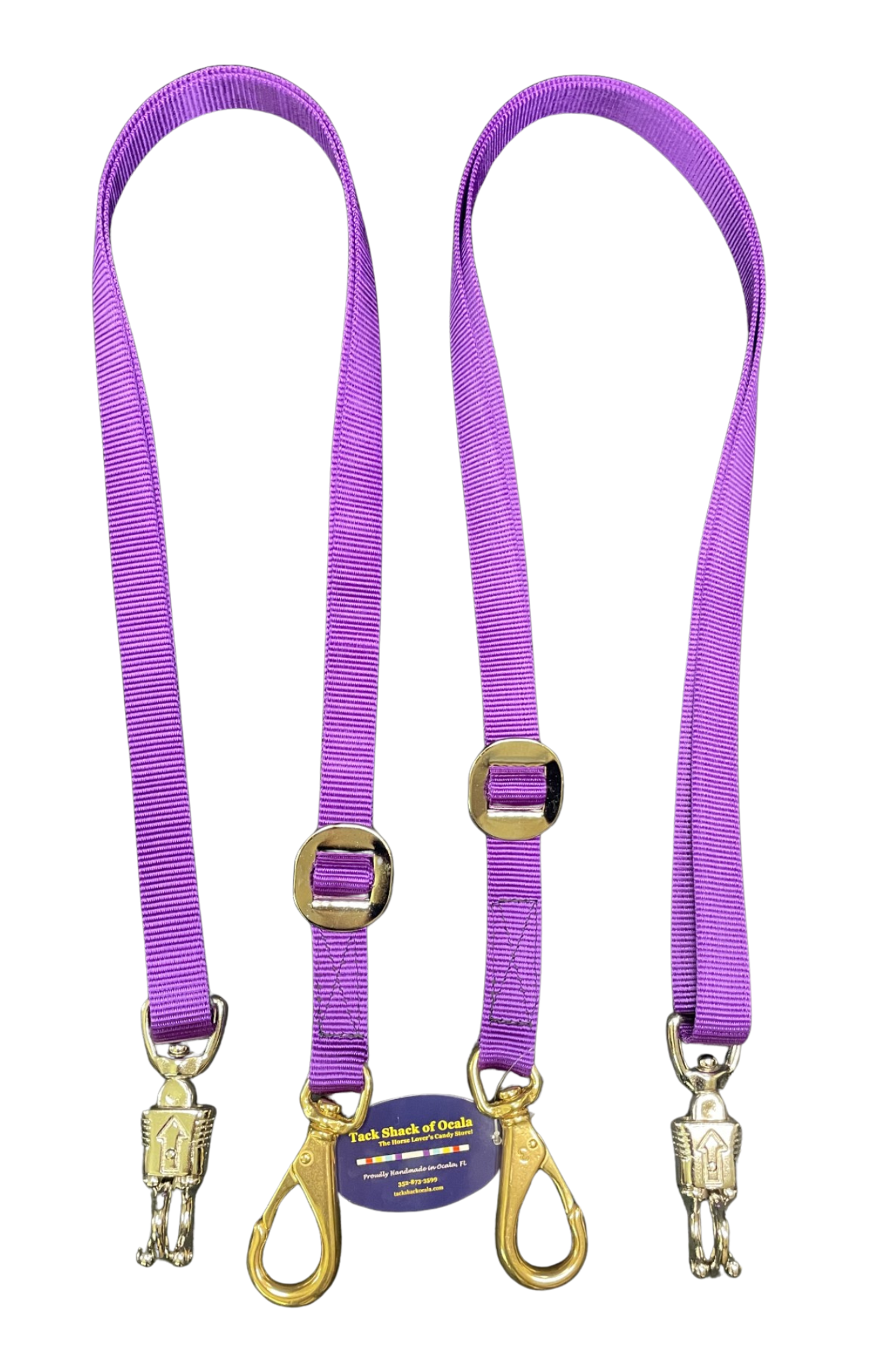 Two purple cross ties with gold hardware on a white background