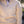 Close-up of a beige quilted jacket with a brand logo on a blurred background