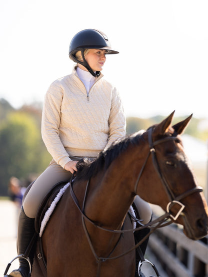 Person riding a horse in an outdoor setting