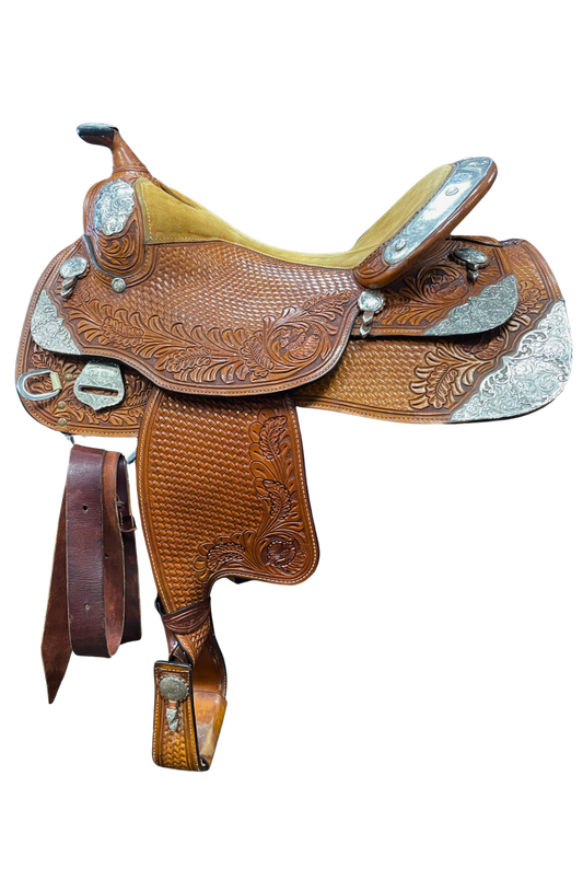 Brown leather saddle with intricate designs on a white background