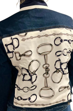 The image displays the back view of a blue denim jacket with a decorative pattern featuring gold and white elements.