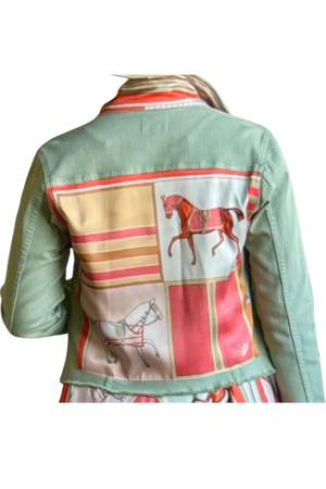 A green denim jacket with a patterned design featuring horses and geometric shapes on the back.