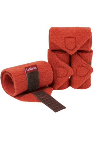 A set of red horse bandages with brown straps.