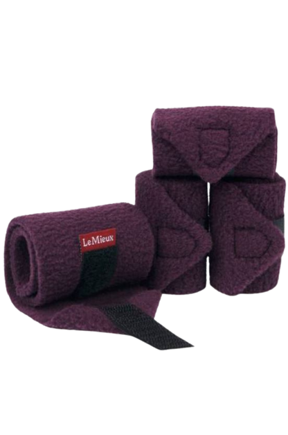 A set of horse bandages with brown straps.