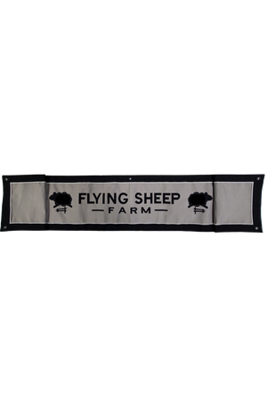 A custom valance banner with the text 'FLYING SHEEP FARM' along with an image of sheep on it, against a black background.
