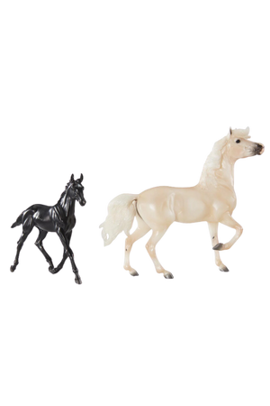 Two toy figures resembling horses, one black and one beige, against a plain background.