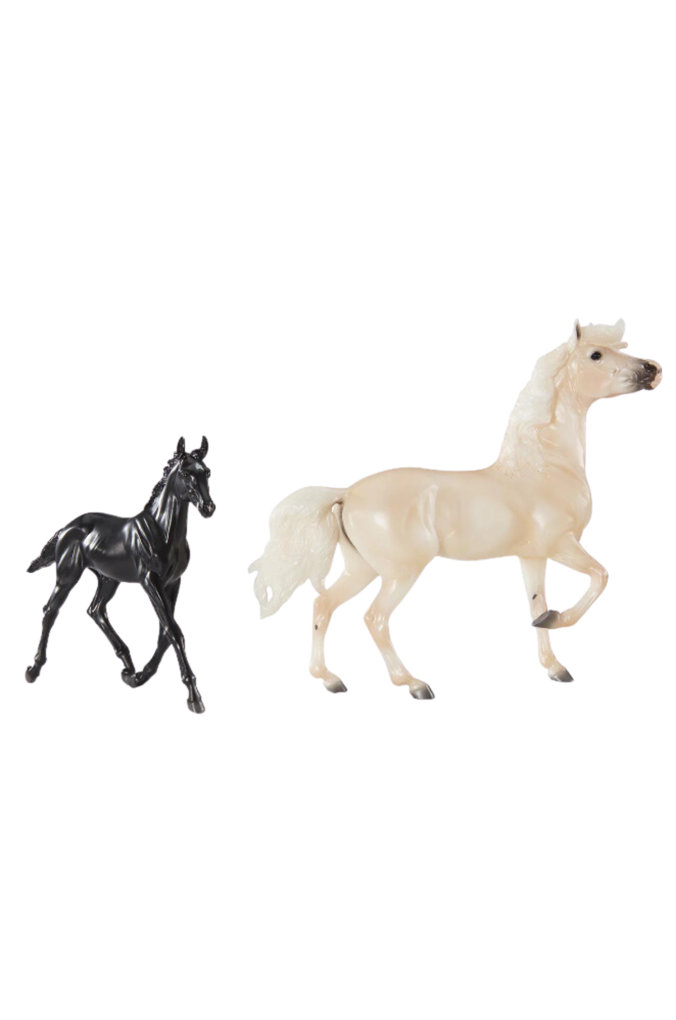 Two toy figures resembling horses, one black and one beige, against a plain background.