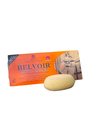 A packaged bar of Belvoir glycerine leather and saddle conditioner next to its orange and yellow packaging.