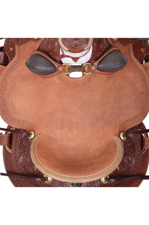 A brown western ranch saddle with floral tooling and black conchos.