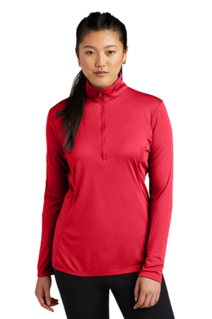 A woman wearing a blue long-sleeved pullover with a quarter zipper at the neck.