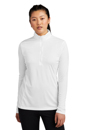 A woman wearing a blue long-sleeved pullover with a quarter zipper at the neck.