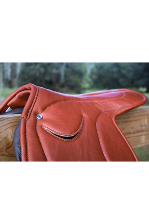 A brown leather exercise saddle with a lightweight aluminum tree, designed for thoroughbred horses.