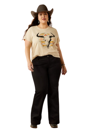 A woman wearing a beige t-shirt with a longhorn watercolor design, paired with blue jeans.